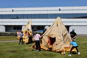 Two groups of young adults pitch Antarctic polar tents.